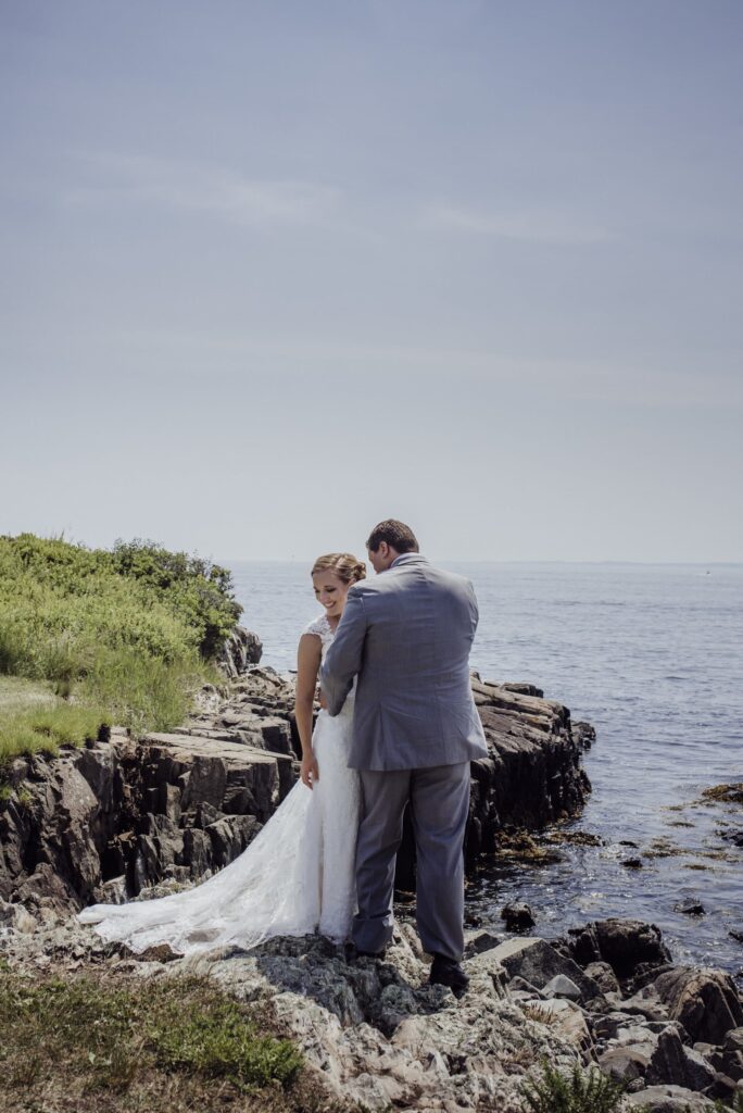 Bride and groom on ocean in kennebunkport maine