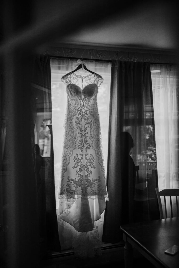 Black and white wedding dress hanging at harbor inn