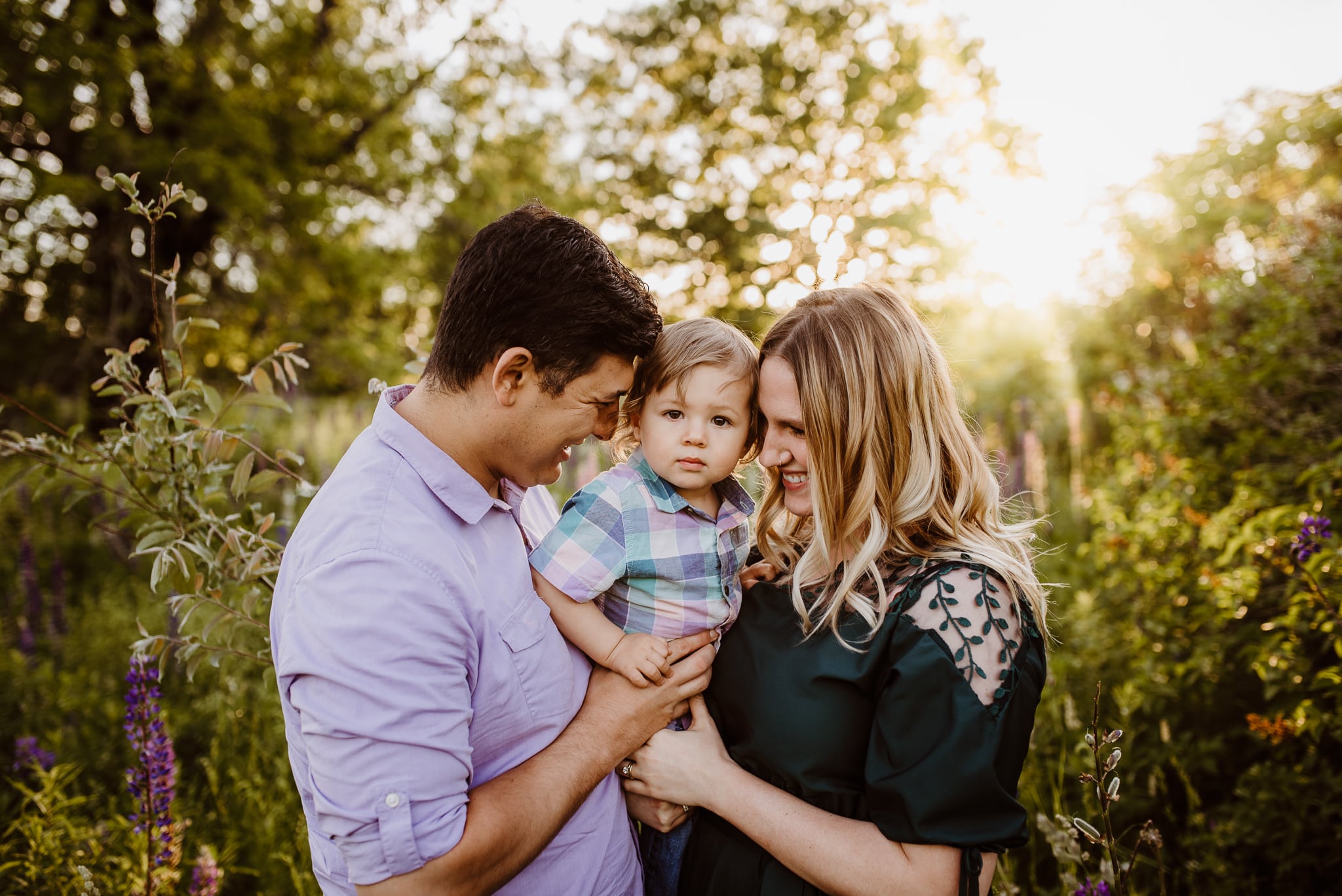 Small family posing together in lupines