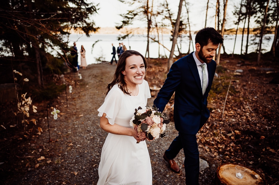 Bride and groom walking away from wedding ceremony in greenville