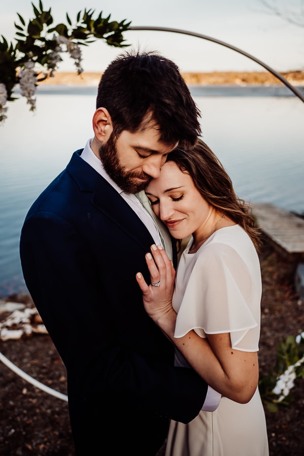 Bride resting her head on grooms chest