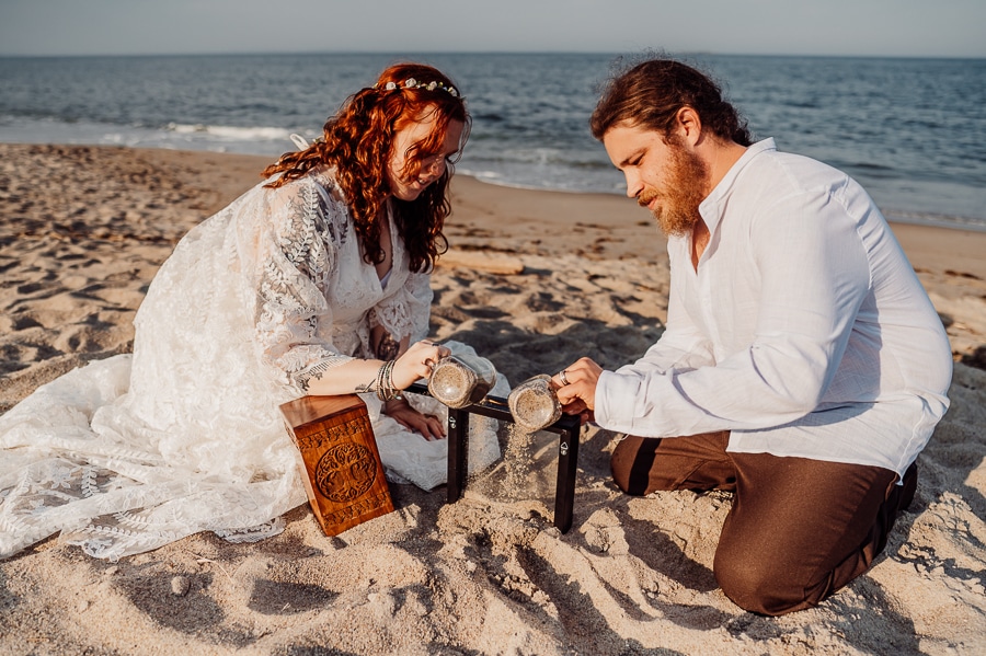 Bride and groom filling shadow box with beach sand