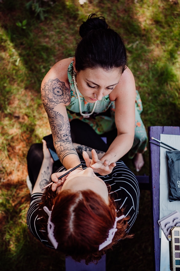 View from above makeup artist doing makeup to bride