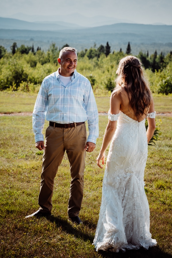 Bride and father sharing first look before wedding