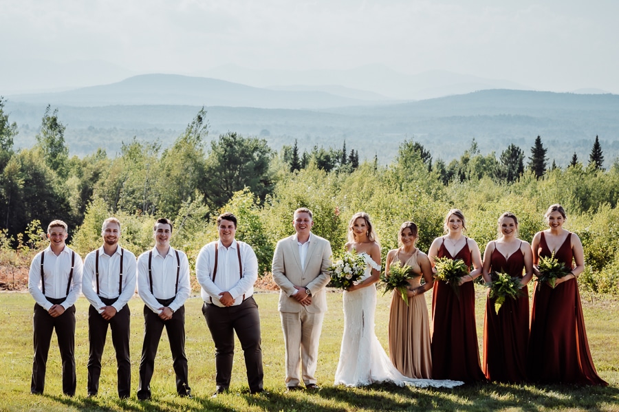 Bride party posing and smiling in madison maine wedding