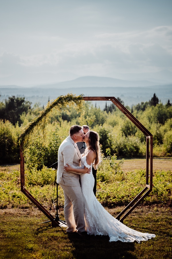 Bride and groom kissing on robbins hill scenic overlook