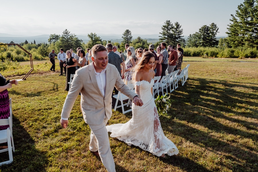 Bride and groom walking down isle after wedding ceremony