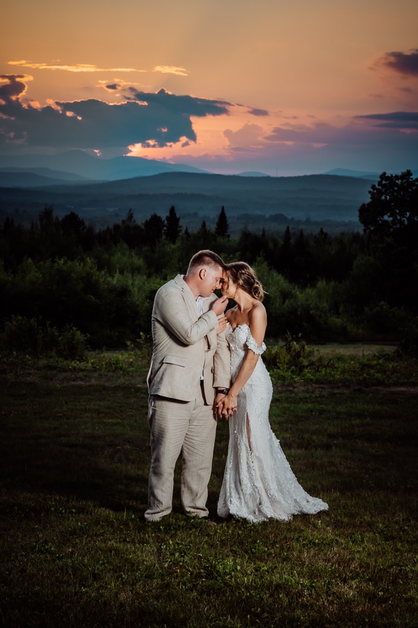 Bride and groom at sunset with a beautiful colorful skyon robbins hill scenic overlook