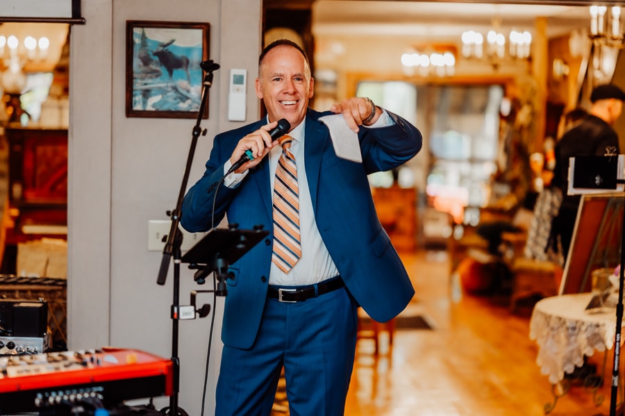 Father of the bride giving speech in dining room at big moose inn wedding reception