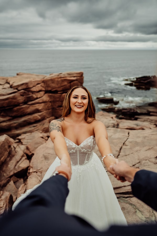 Bride holding hands with groom from grooms perspective in bar harbor