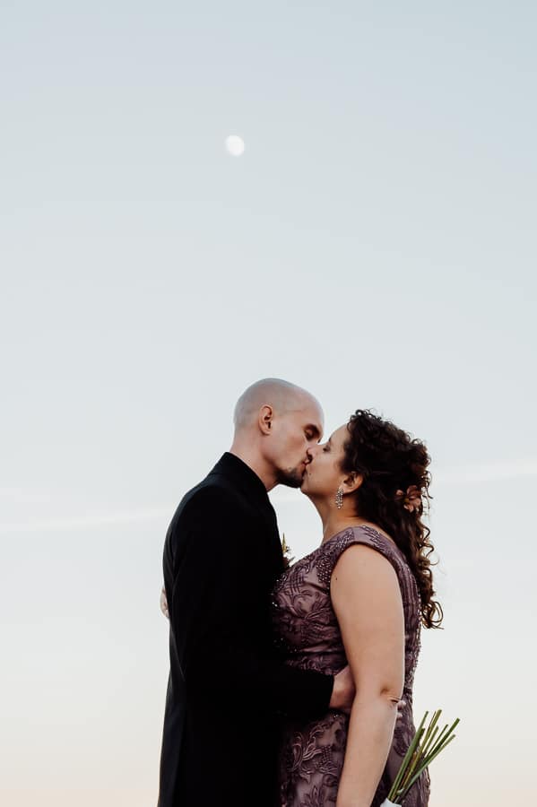 bride and groom kissing under the moon in nelson ghost town vegas