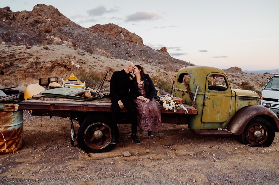 couple sitting on bed of old truck at nelson ghost town