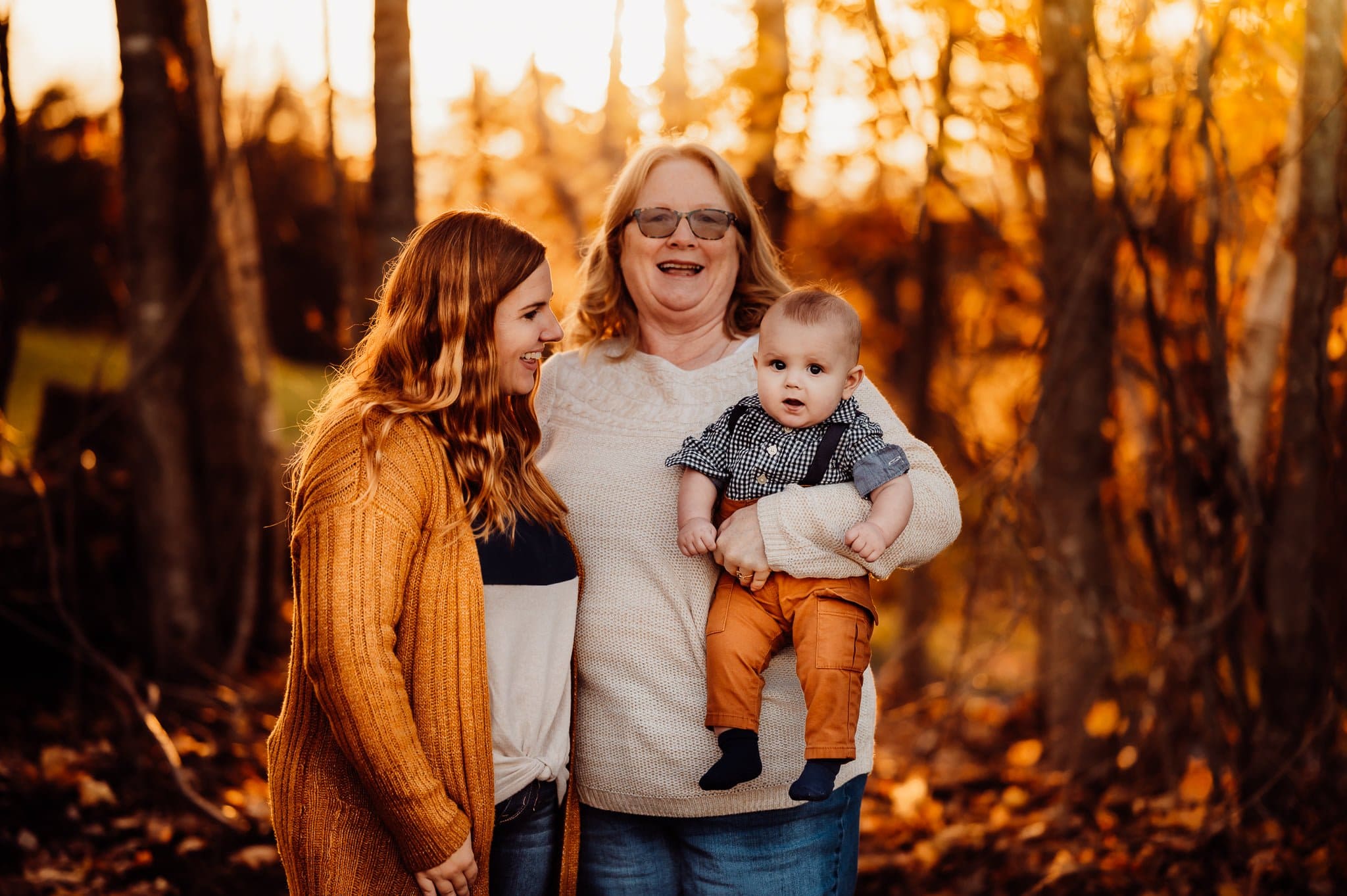 Grandmother mother and baby against fall background