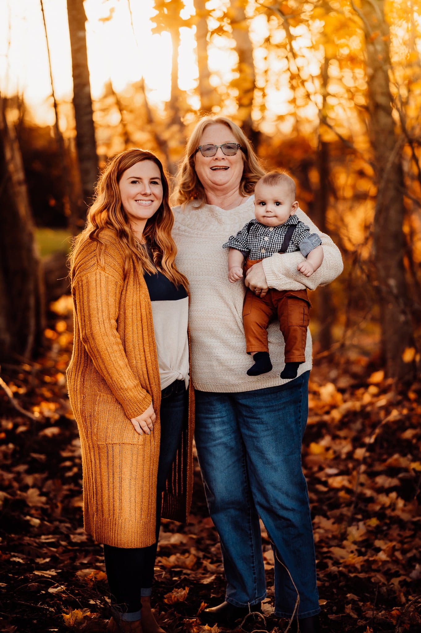 Grandmother mother and baby against fall background