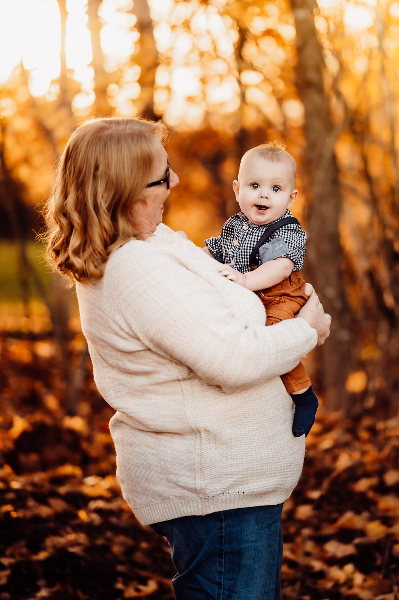 grandmother holding smiling baby