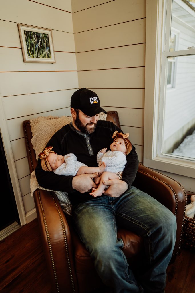 Twin newborn girls posing in home