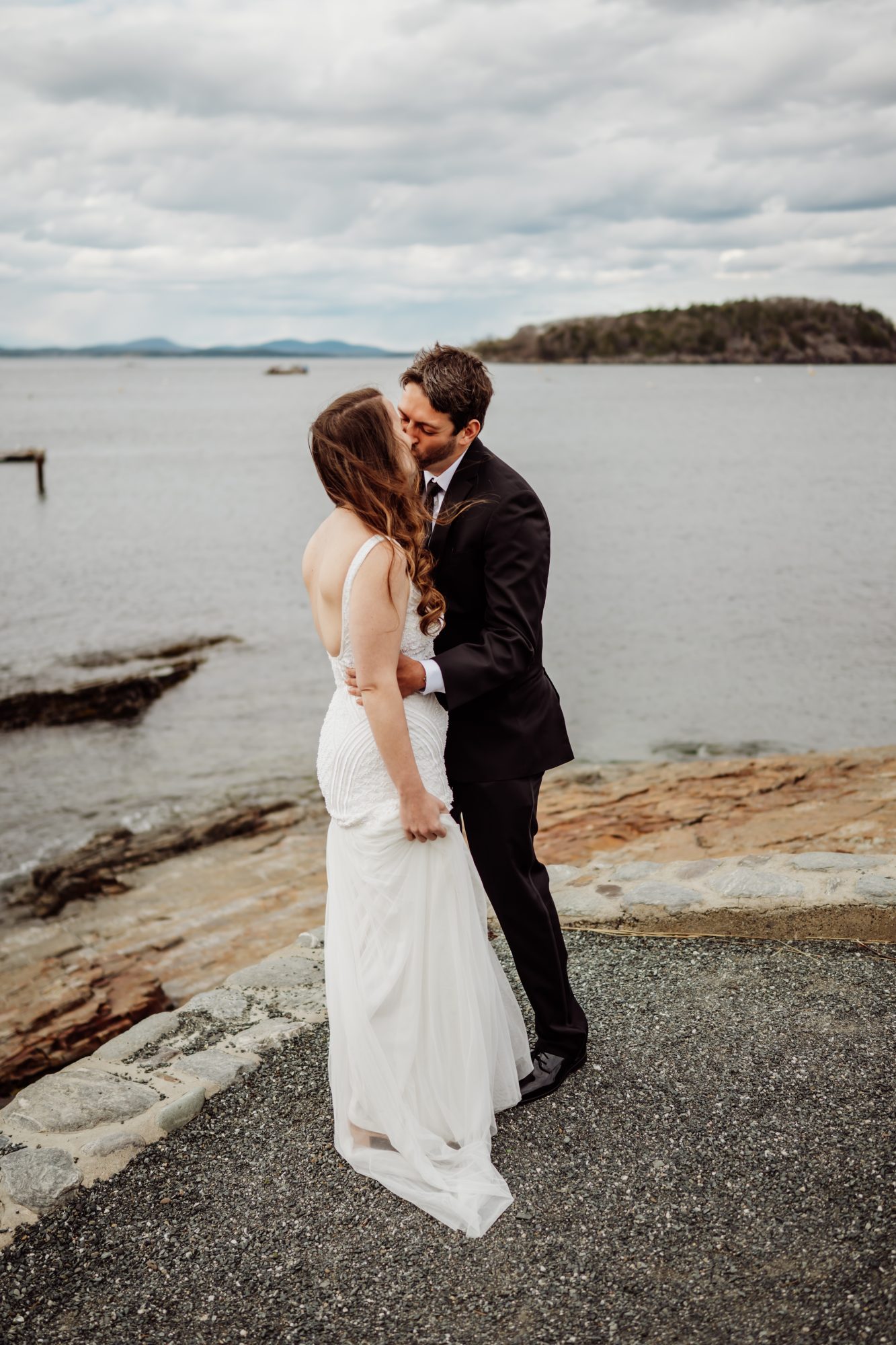 Romantic kiss by the ocean during an Acadia National Park elopement near Frenchman Bay